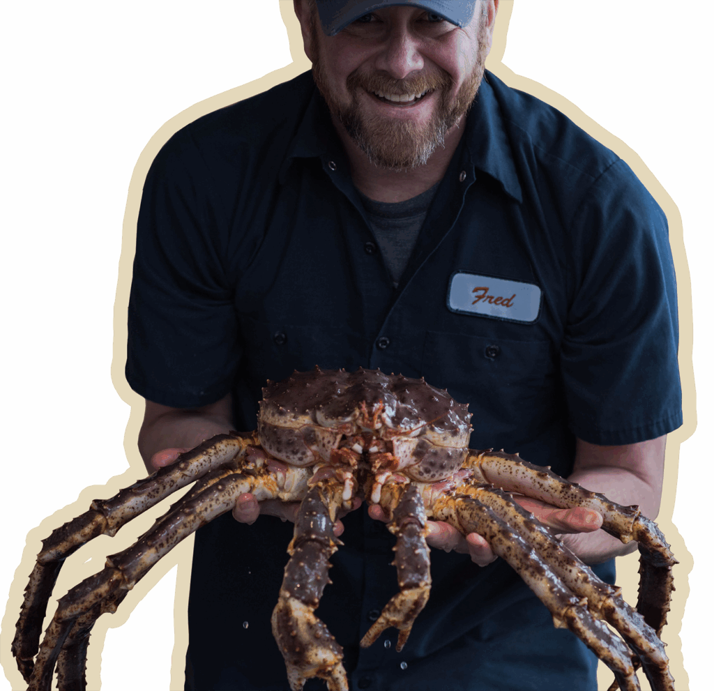 photo of a smiling fred holding a king crab