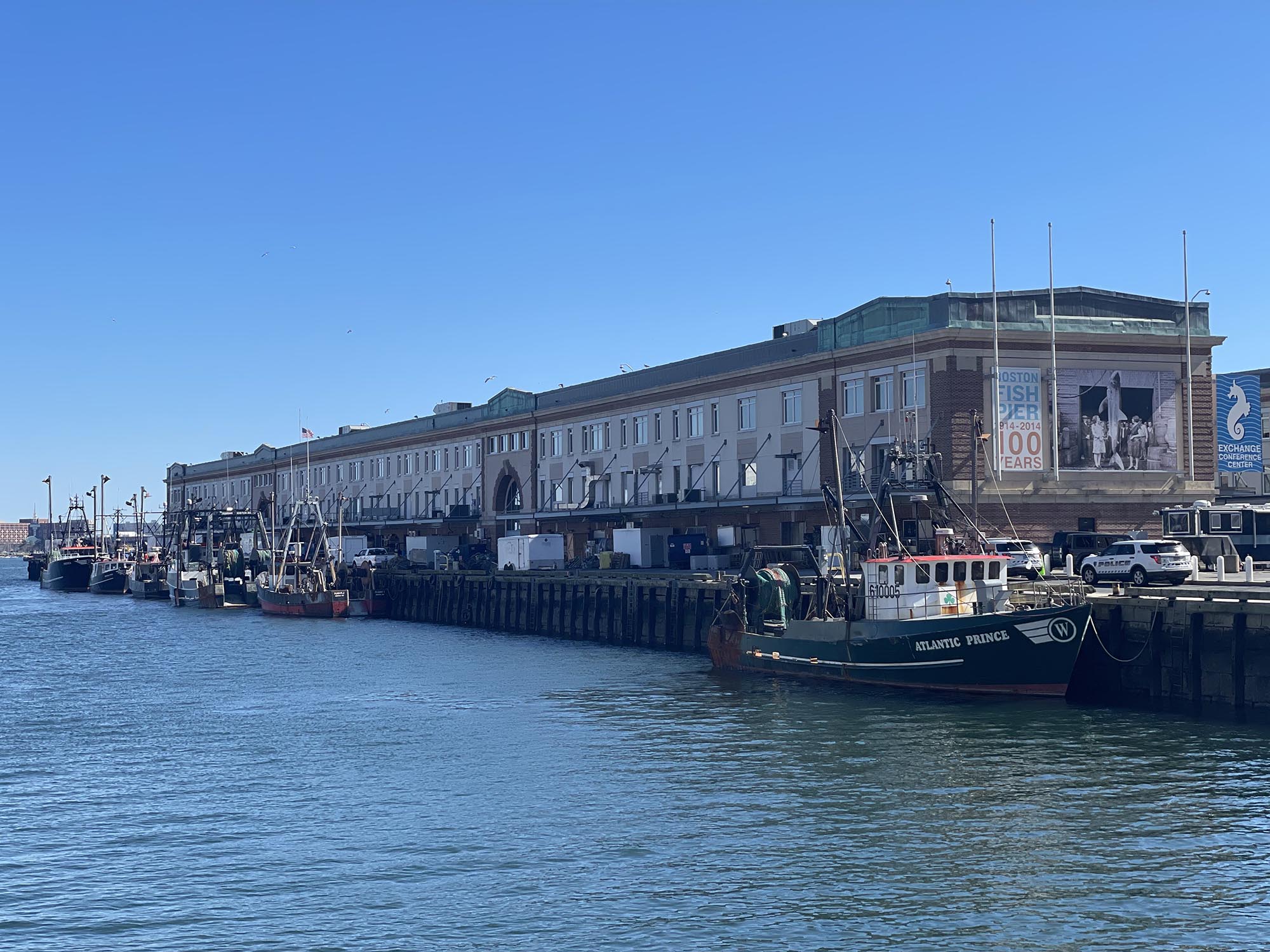 image of the port of newburyport with many fishing vessels parked to the side