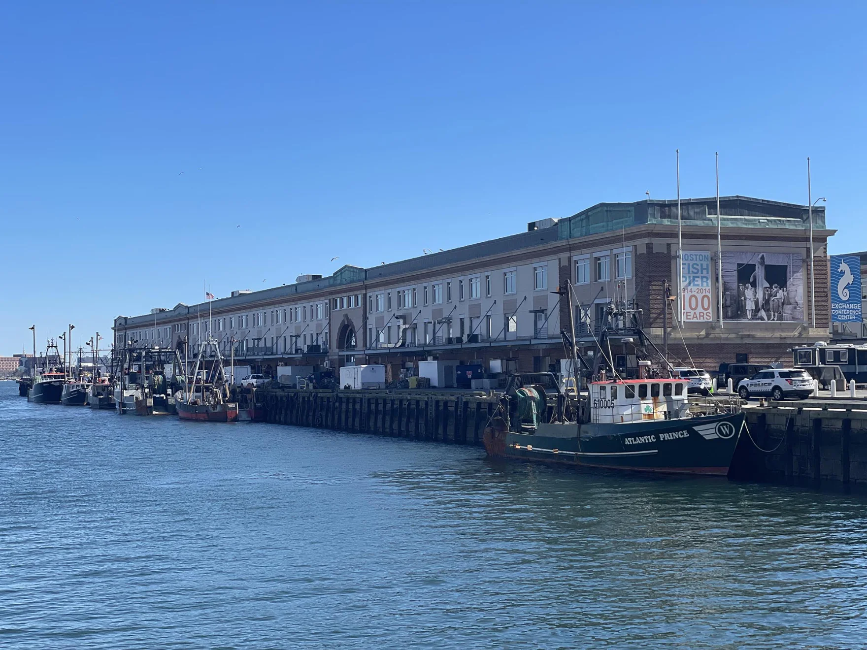 image of the port of newburyport with many fishing vessels parked to the side